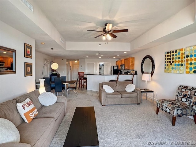 4800 Eagleview Dr Unit 6104, Osage Beach, MO 65065 - living area featuring light colored carpet, ceiling fan, a raised ceiling, and recessed lighting