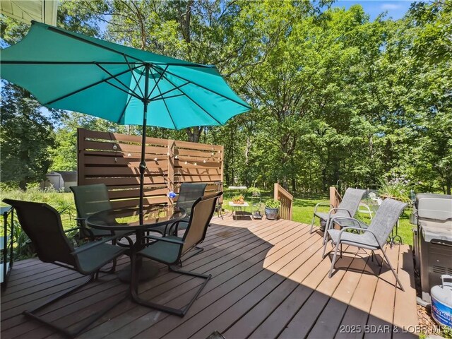 204 Wellington Ln, Laurie, MO 65037 - wooden deck with outdoor dining space
