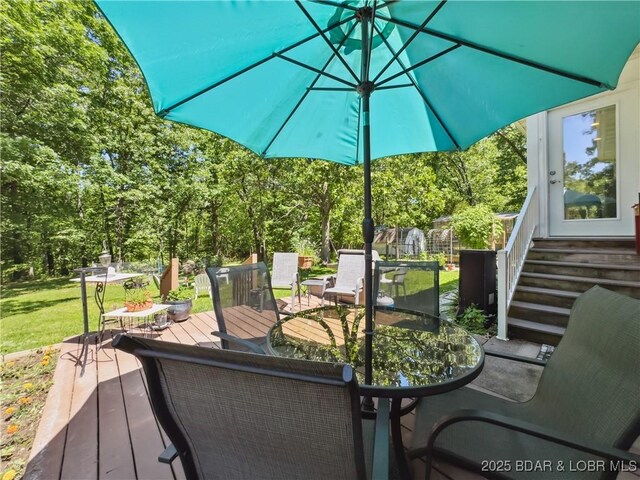 204 Wellington Ln, Laurie, MO 65037 - wooden terrace featuring outdoor dining area and a lawn