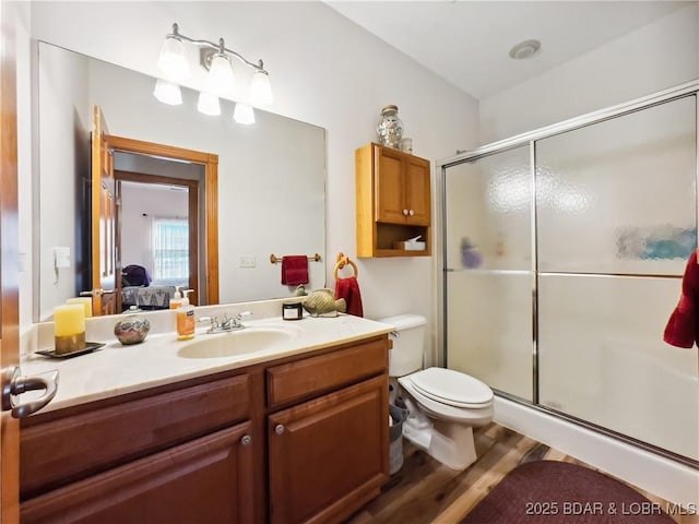 204 Wellington Ln, Laurie, MO 65037 - ensuite bathroom with vanity, a stall shower, wood finished floors, and toilet