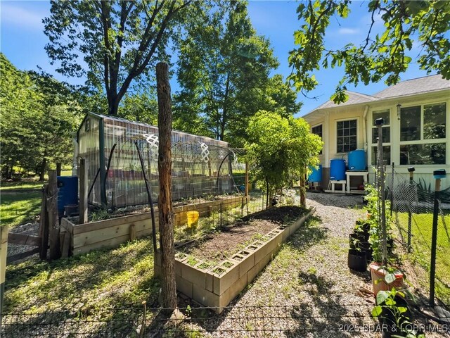 204 Wellington Ln, Laurie, MO 65037 - view of yard featuring a garden, an exterior structure, and an outdoor structure