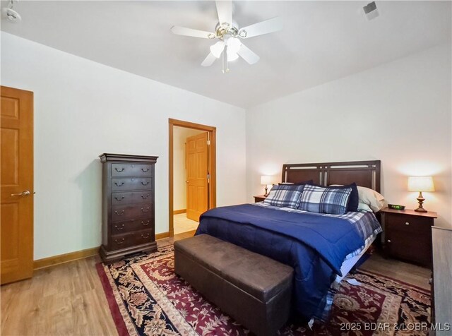 204 Wellington Ln, Laurie, MO 65037 - bedroom featuring wood finished floors, a ceiling fan, and baseboards