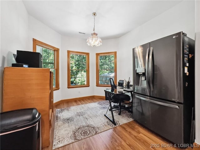 204 Wellington Ln, Laurie, MO 65037 - office area with wood finished floors, a chandelier, and baseboards