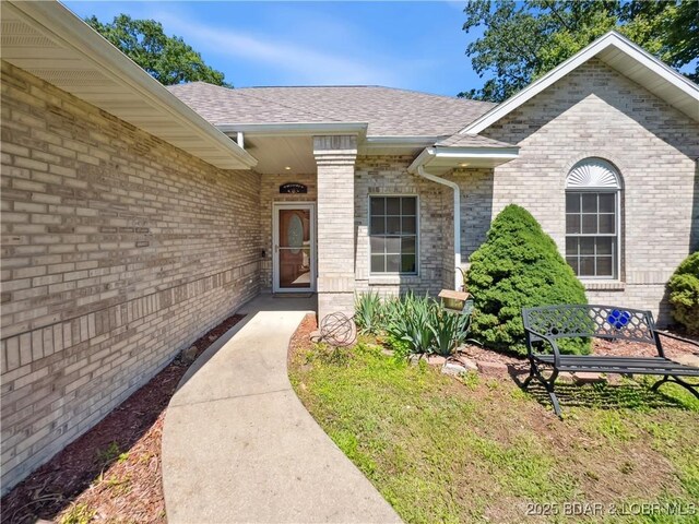 204 Wellington Ln, Laurie, MO 65037 - view of exterior entry with brick siding and roof with shingles