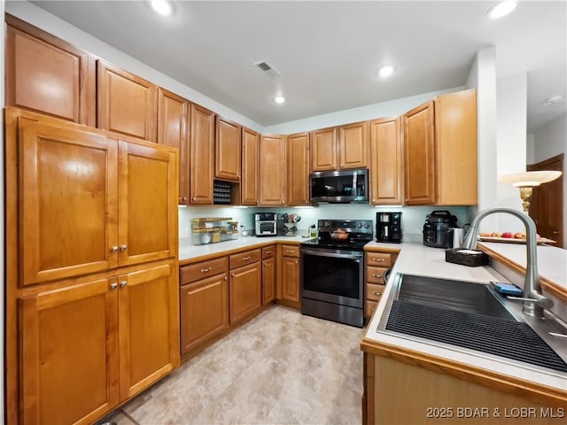 204 Wellington Ln, Laurie, MO 65037 - kitchen featuring stainless steel appliances, a sink, light countertops, and recessed lighting