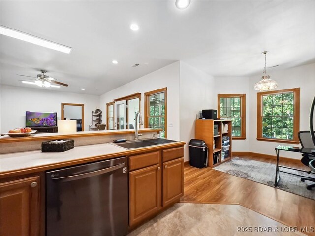 204 Wellington Ln, Laurie, MO 65037 - kitchen featuring dishwasher, a sink, light wood-type flooring, recessed lighting, and decorative light fixtures