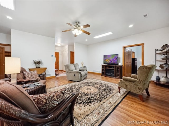 204 Wellington Ln, Laurie, MO 65037 - living area featuring light wood finished floors, a ceiling fan, recessed lighting, and baseboards