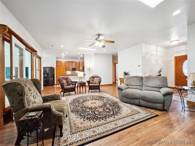 204 Wellington Ln, Laurie, MO 65037 - living room with light wood-style flooring, a ceiling fan, recessed lighting, and baseboards