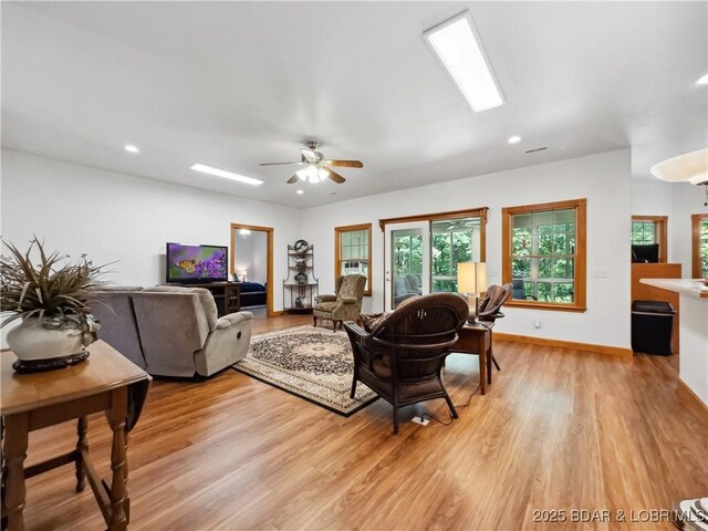 204 Wellington Ln, Laurie, MO 65037 - living room featuring light wood-type flooring, a ceiling fan, recessed lighting, and baseboards