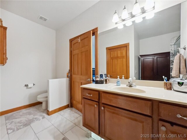 204 Wellington Ln, Laurie, MO 65037 - bathroom with vanity, toilet, and baseboards