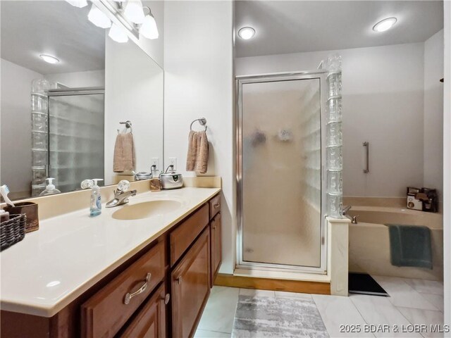 204 Wellington Ln, Laurie, MO 65037 - bathroom featuring vanity, a shower stall, a garden tub, and tile patterned floors