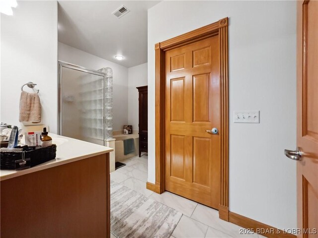 204 Wellington Ln, Laurie, MO 65037 - full bathroom featuring a shower stall, a garden tub, and vanity