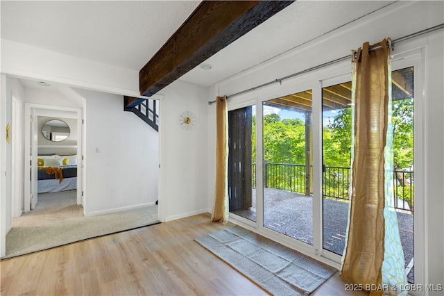 491 Walkers Cay, Osage Beach, MO 65065 - entryway featuring wood finished floors, beam ceiling, and baseboards