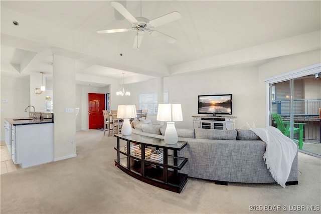 184 E Palisades Condo Dr Unit 4A, Lake Ozark, MO 65049 - living area featuring light carpet, ceiling fan, baseboards, and a chandelier