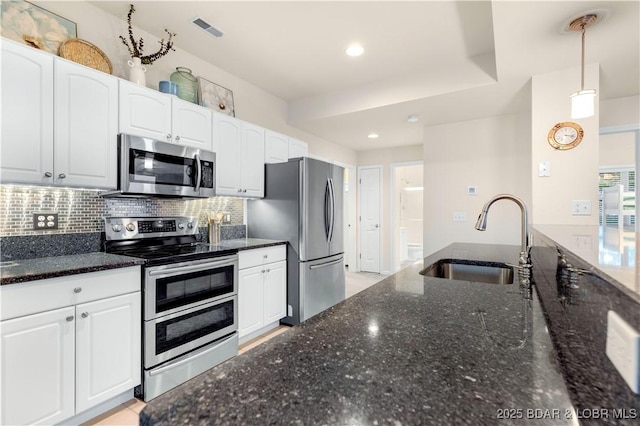 184 E Palisades Condo Dr Unit 4A, Lake Ozark, MO 65049 - kitchen featuring appliances with stainless steel finishes, a sink, white cabinets, decorative backsplash, and recessed lighting