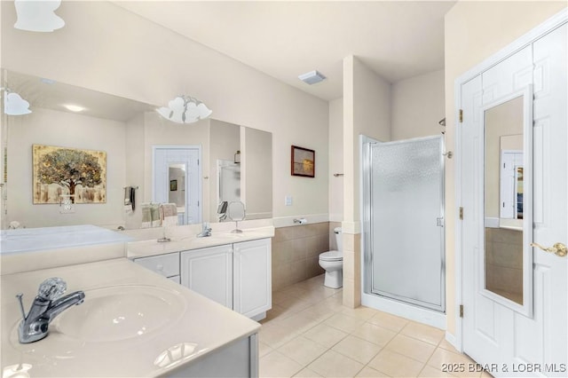 184 E Palisades Condo Dr Unit 4A, Lake Ozark, MO 65049 - bathroom with tile patterned floors, a stall shower, vanity, toilet, and tile walls