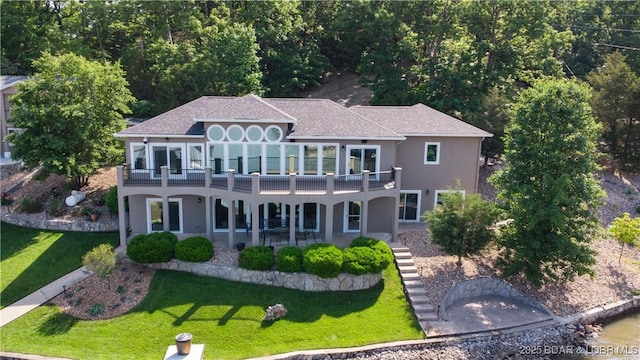 55 Shagbark Dr, Sunrise Beach, MO 65079 - back of property featuring a lawn, stucco siding, and a patio