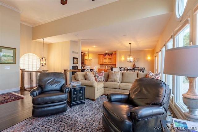 55 Shagbark Dr, Sunrise Beach, MO 65079 - living room featuring a chandelier, dark wood finished floors, baseboards, and ornamental molding