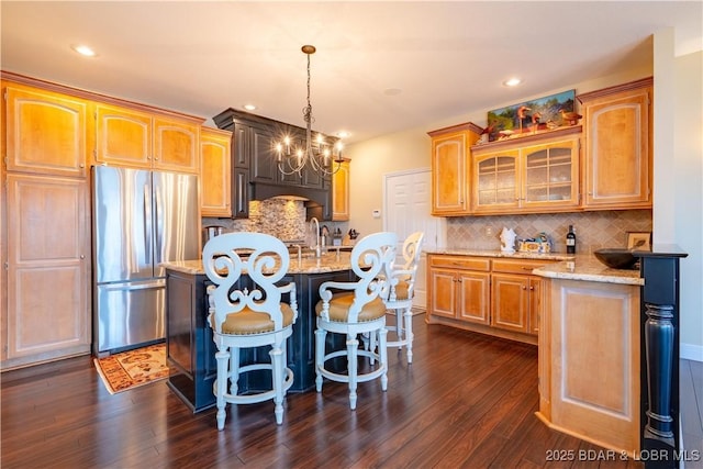 55 Shagbark Dr, Sunrise Beach, MO 65079 - kitchen featuring freestanding refrigerator, a chandelier, backsplash, light stone countertops, and recessed lighting