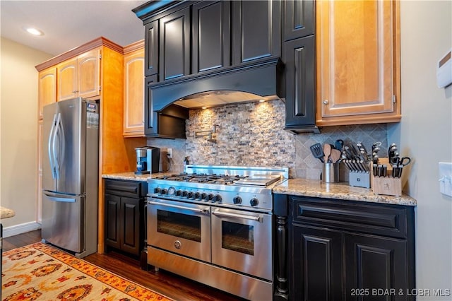 55 Shagbark Dr, Sunrise Beach, MO 65079 - kitchen featuring appliances with stainless steel finishes, wood finished floors, custom range hood, backsplash, and light stone counters