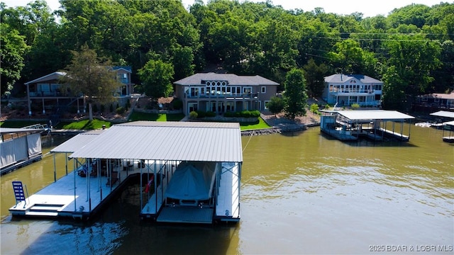 55 Shagbark Dr, Sunrise Beach, MO 65079 - dock area featuring boat lift, a water view, and a view of trees