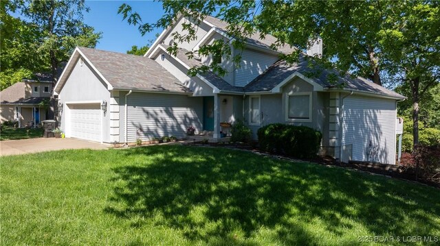 1396 Robyn Ct, Osage Beach, MO 65065 - view of front of home with a chimney, an attached garage, driveway, and a front lawn
