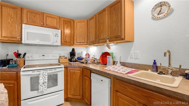 1396 Robyn Ct, Osage Beach, MO 65065 - kitchen with white appliances, a sink, brown cabinets, and a textured wall