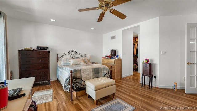 1396 Robyn Ct, Osage Beach, MO 65065 - bedroom featuring light wood-style floors, a walk in closet, recessed lighting, a ceiling fan, and baseboards