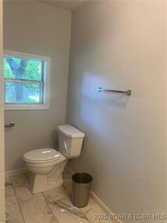 34443 Ivy Bend Rd, Stover, MO 65078 - bathroom with toilet, marble look tile flooring, and baseboards