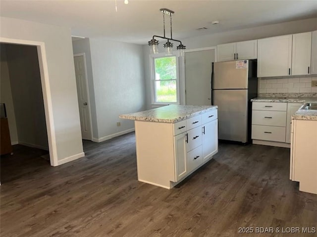 34443 Ivy Bend Rd, Stover, MO 65078 - kitchen featuring freestanding refrigerator, white cabinetry, backsplash, baseboards, and dark wood-style floors