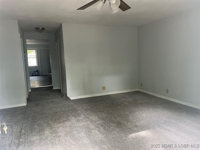34443 Ivy Bend Rd, Stover, MO 65078 - empty room featuring dark colored carpet, a ceiling fan, and baseboards
