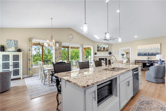 980 Eagle Dr, Lake Ozark, MO 65049 - kitchen with a sink, open floor plan, a fireplace, stainless steel appliances, and light wood finished floors
