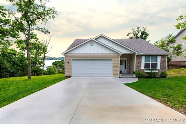 980 Eagle Dr, Lake Ozark, MO 65049 - view of front of home featuring a garage, a front yard, concrete driveway, and roof with shingles