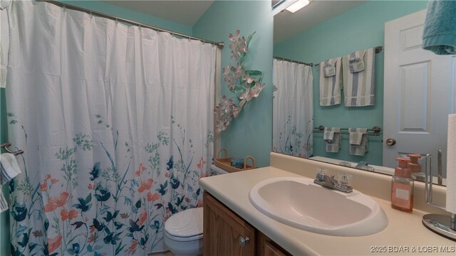 312 Windsor Bay Dr Unit 2A, Camdenton, MO 65020 - full bathroom with vanity, toilet, and curtained shower