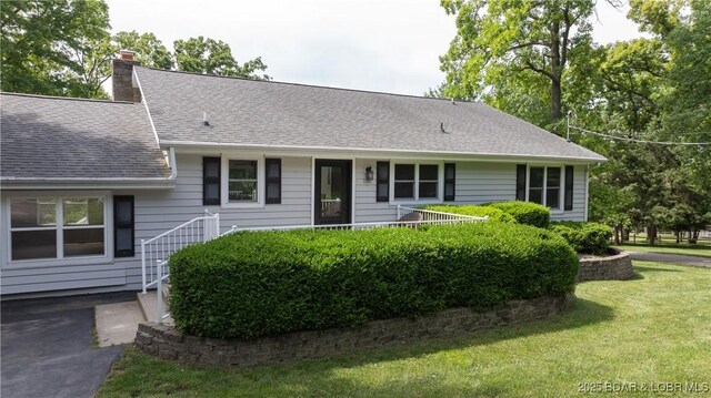 288 Oak Ridge Rd, Lake Ozark, MO 65049 - view of front of property with a front lawn, a chimney, and a shingled roof