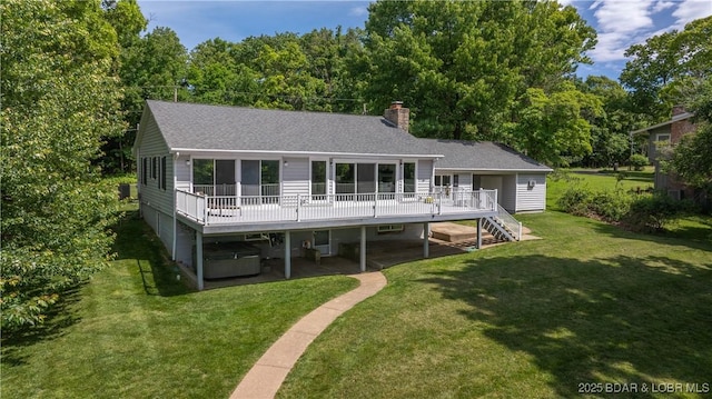 288 Oak Ridge Rd, Lake Ozark, MO 65049 - back of house with a hot tub, a wooden deck, a chimney, roof with shingles, and a yard