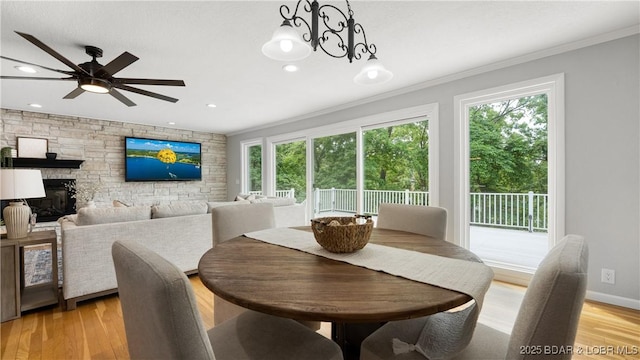 288 Oak Ridge Rd, Lake Ozark, MO 65049 - dining area featuring ornamental molding, light wood finished floors, a ceiling fan, recessed lighting, and a fireplace