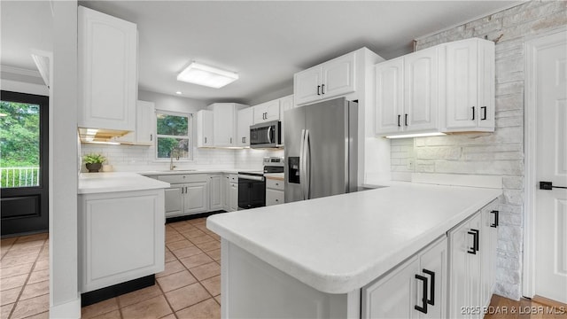 288 Oak Ridge Rd, Lake Ozark, MO 65049 - kitchen with stainless steel appliances, healthy amount of natural light, and white cabinetry