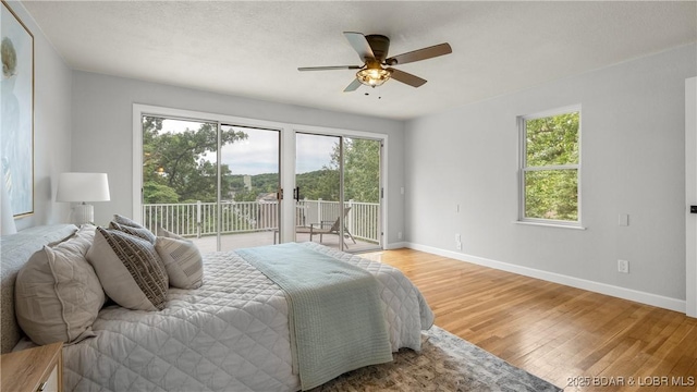 288 Oak Ridge Rd, Lake Ozark, MO 65049 - bedroom with access to outside, light wood-style flooring, and multiple windows