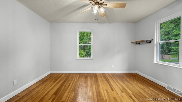 288 Oak Ridge Rd, Lake Ozark, MO 65049 - empty room with hardwood / wood-style flooring, healthy amount of natural light, and a ceiling fan