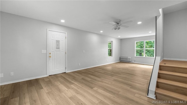 288 Oak Ridge Rd, Lake Ozark, MO 65049 - unfurnished room with a ceiling fan, a wall mounted air conditioner, light wood-style flooring, recessed lighting, and stairs