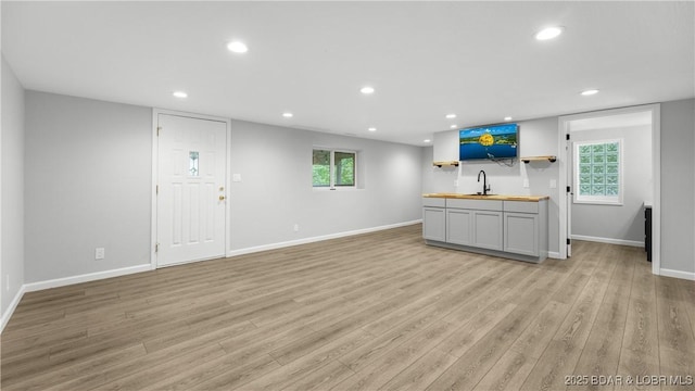 288 Oak Ridge Rd, Lake Ozark, MO 65049 - unfurnished living room with wet bar, light wood-type flooring, and recessed lighting