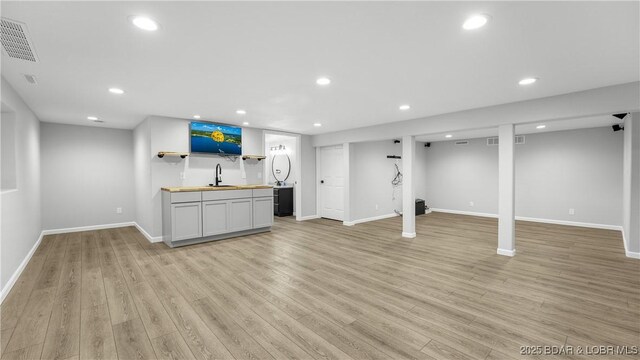 288 Oak Ridge Rd, Lake Ozark, MO 65049 - finished below grade area with wet bar, light wood finished floors, baseboards, and recessed lighting