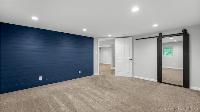 288 Oak Ridge Rd, Lake Ozark, MO 65049 - unfurnished bedroom featuring carpet, recessed lighting, a barn door, and baseboards
