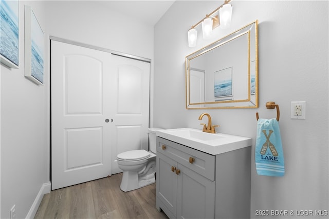 584 Black Hawk Dr, Lake Ozark, MO 65049 - bathroom with wood finished floors, vanity, and toilet