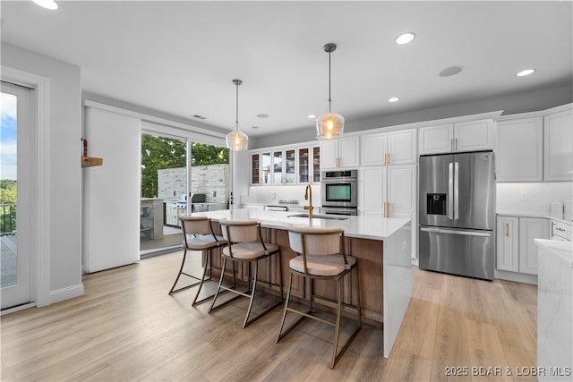 584 Black Hawk Dr, Lake Ozark, MO 65049 - kitchen with stainless steel refrigerator with ice dispenser, light wood-style floors, light countertops, white cabinets, and recessed lighting