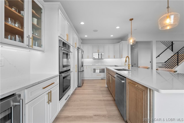 584 Black Hawk Dr, Lake Ozark, MO 65049 - kitchen with wine cooler, a sink, appliances with stainless steel finishes, light wood-style flooring, and recessed lighting