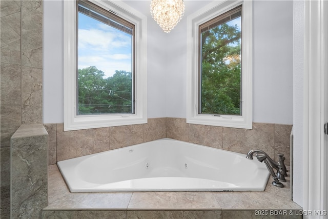 584 Black Hawk Dr, Lake Ozark, MO 65049 - bathroom featuring a whirlpool tub and a chandelier