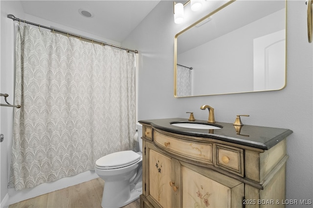 584 Black Hawk Dr, Lake Ozark, MO 65049 - full bath with vanity, toilet, wood finished floors, and shower / bath combo with shower curtain