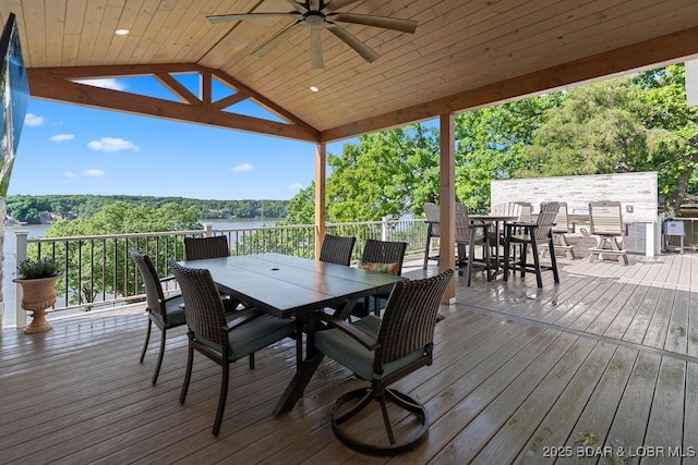 584 Black Hawk Dr, Lake Ozark, MO 65049 - wooden deck featuring outdoor dining space, a ceiling fan, and a water view